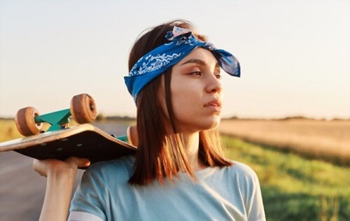 how to hold a skateboard while walking